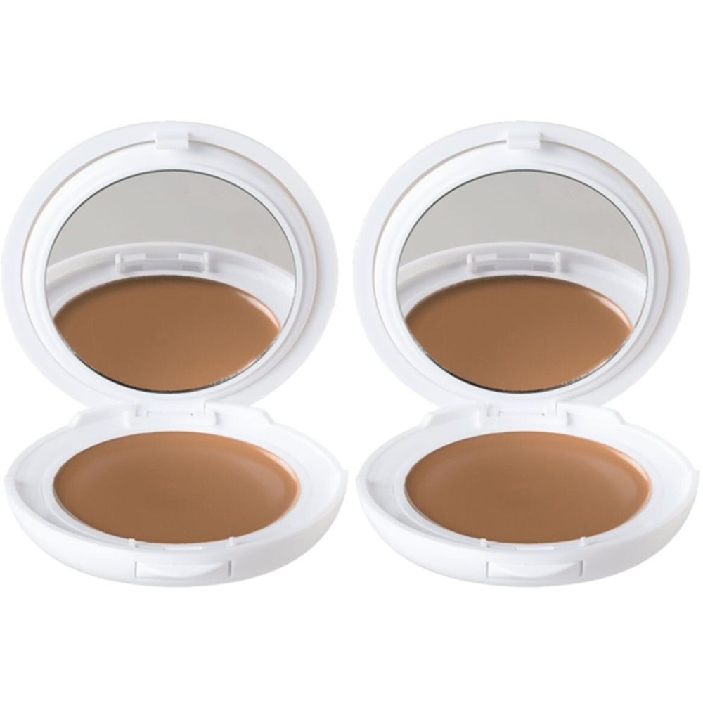 Deux compacts blancs ronds ouverts. Miroir et produit teinté brun. Couvercle avec miroir.