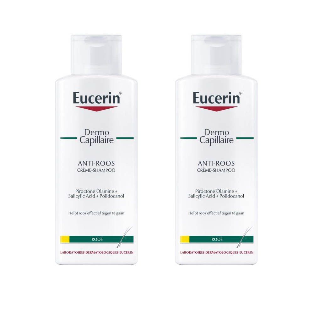Zwei Flaschen Eucerin DermoCapillaire Anti-Schuppen Shampoo. Weiße Flaschen mit rotem und grünem Etikett. Text: Anti-Roos Crème-Shampoo.