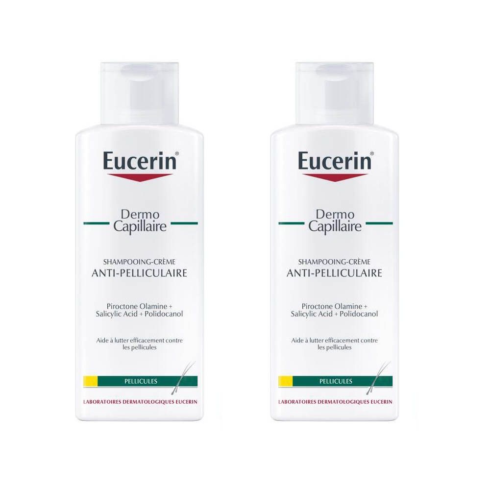 Deux flacons de shampooing Eucerin DermoCapillaire Anti-Pelliculaire. Flacons blancs avec étiquette rouge et verte. Texte: Anti-Pelliculaire Shampooing-Crème.