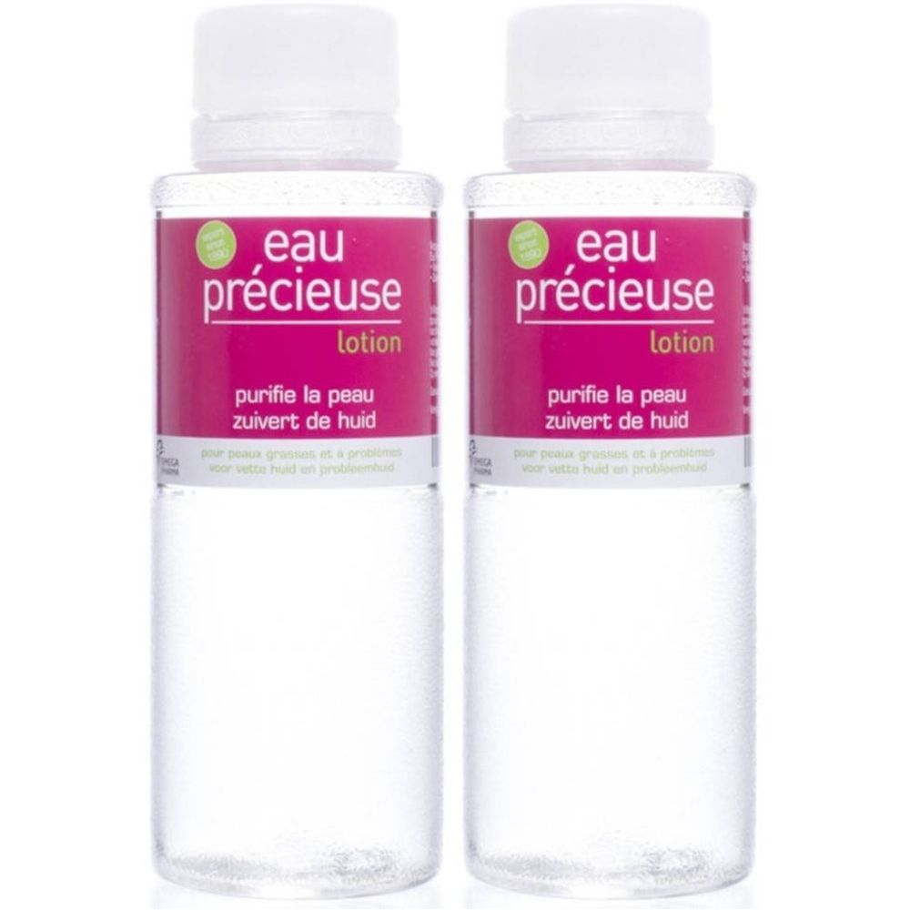 Deux flacons de lotion Eau Précieuse. Bouchons blancs, étiquette rose avec texte. Liquide clair dans des flacons transparents.