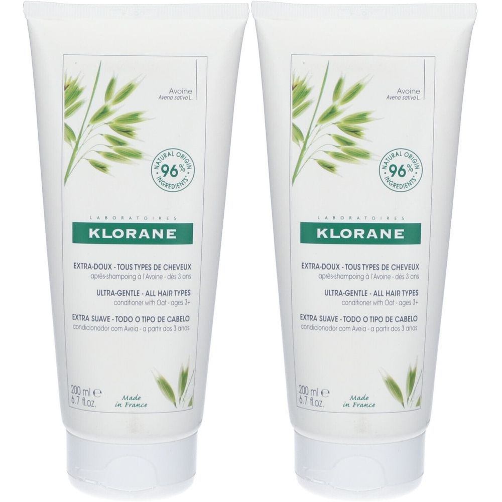 Deux tubes de KLORANE Baume au lait d'avoine. Tubes blancs avec accents verts et informations produit. 96% ingrédients naturels.