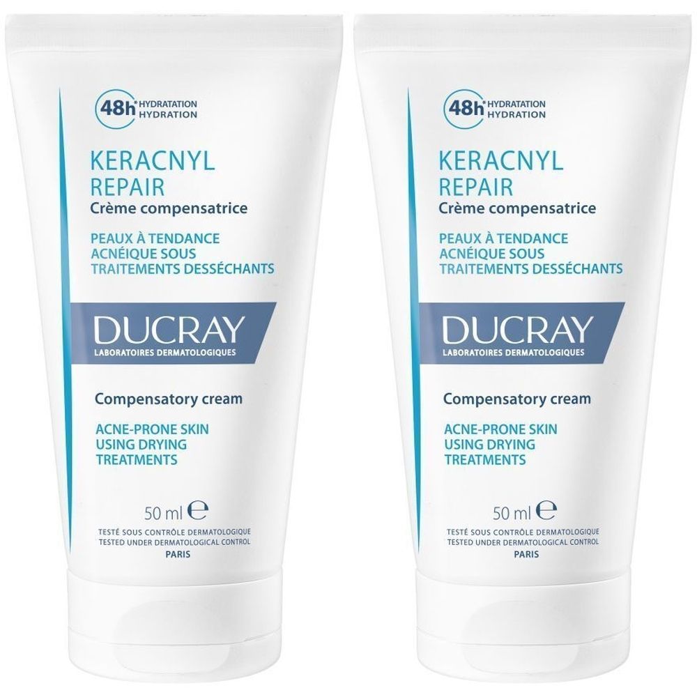 Deux tubes de crème DUCRAY KERACNYL REPAIR. Tubes blancs avec texte bleu et noir. Contient 50 ml.