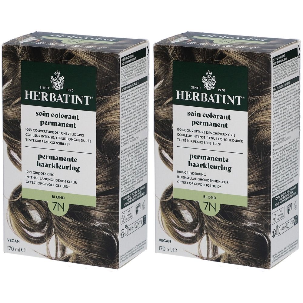 Zwei Packungen Herbatint Soin Coloration Permanente 7N Blond. Grün-braune Verpackung mit Produktinformationen und Haarabbildung.