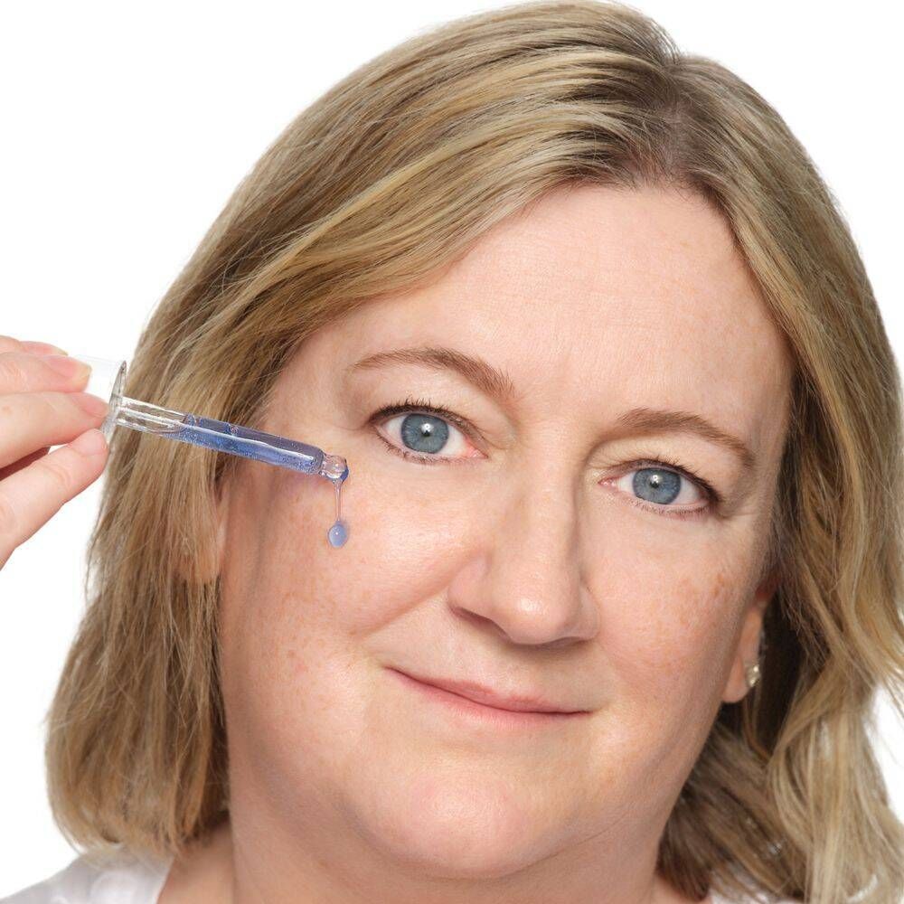 Une femme applique le sérum The Ordinary Multi-Peptide + Copper Peptides 1% avec un compte-gouttes.