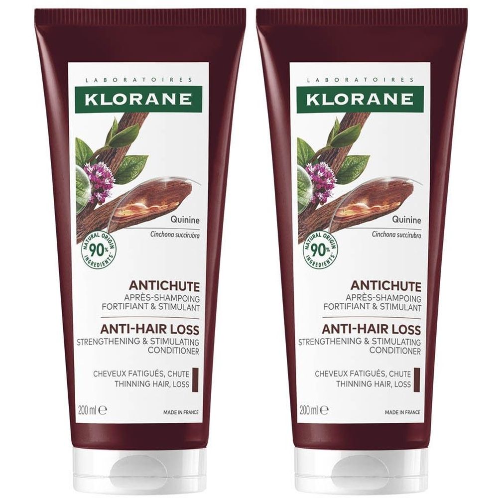 Deux tubes de revitalisant capillaire. Étiquette blanche avec logo, nom du produit et ingrédients. Tube marron, bouchon blanc.