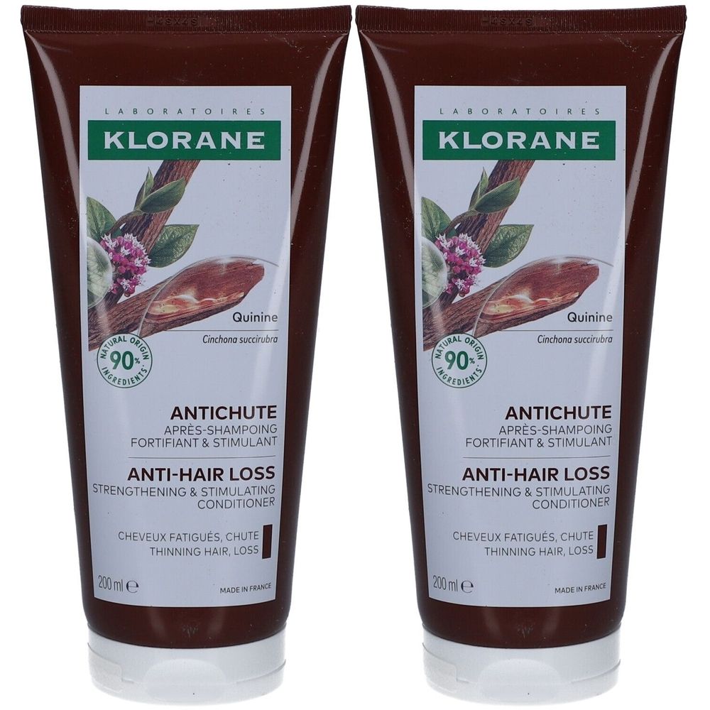 Deux tubes de revitalisant capillaire. Étiquette blanche avec logo, nom du produit et ingrédients. Tube marron, bouchon blanc.