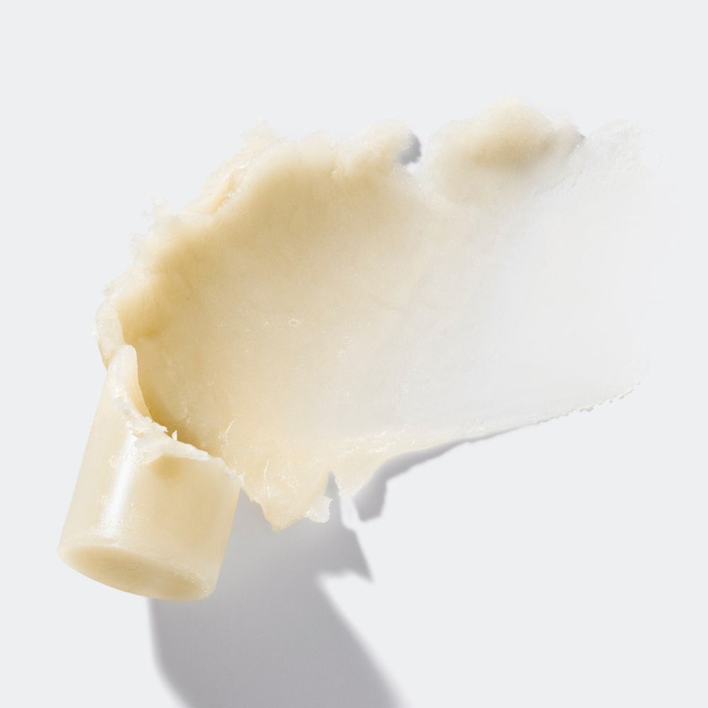 Creme-Textur-Abstrich auf weißem Hintergrund. Ein Teil des Produkts ist sichtbar.