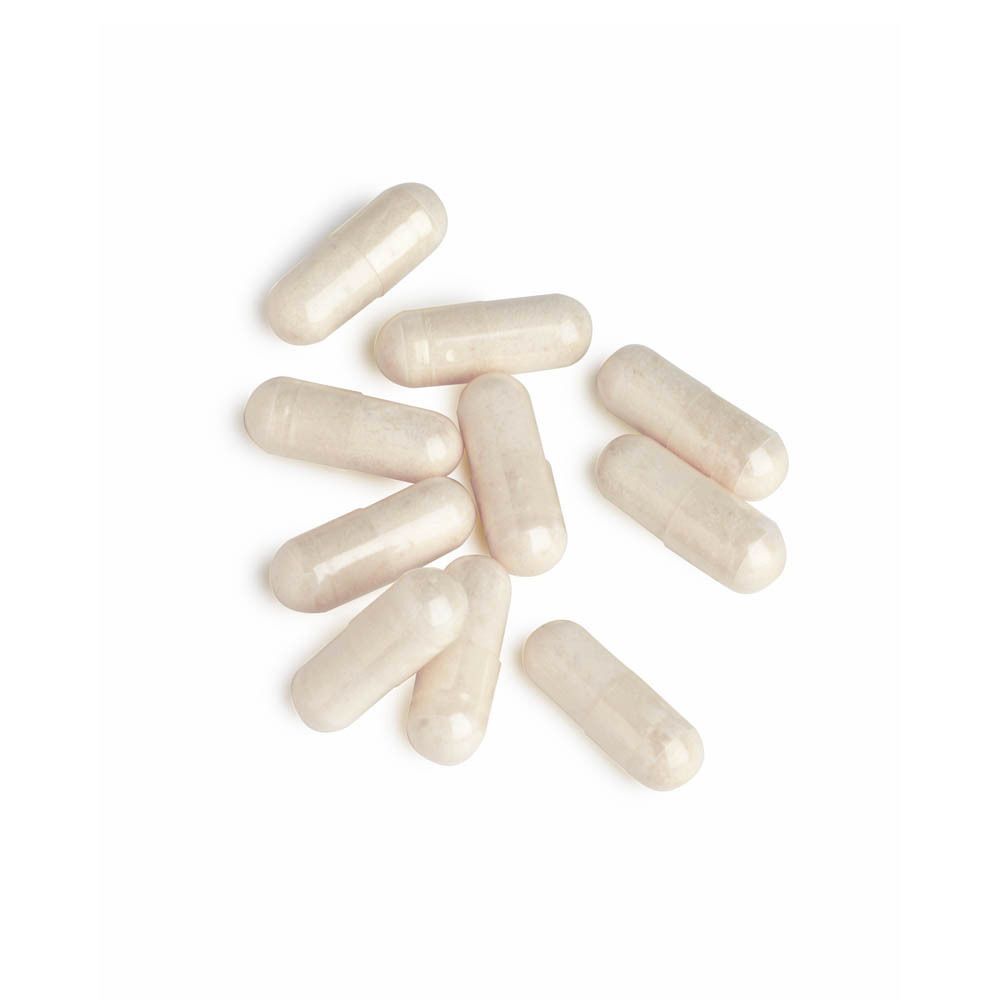 Plusieurs gélules blanches de ChondroSamine-S sur fond blanc.