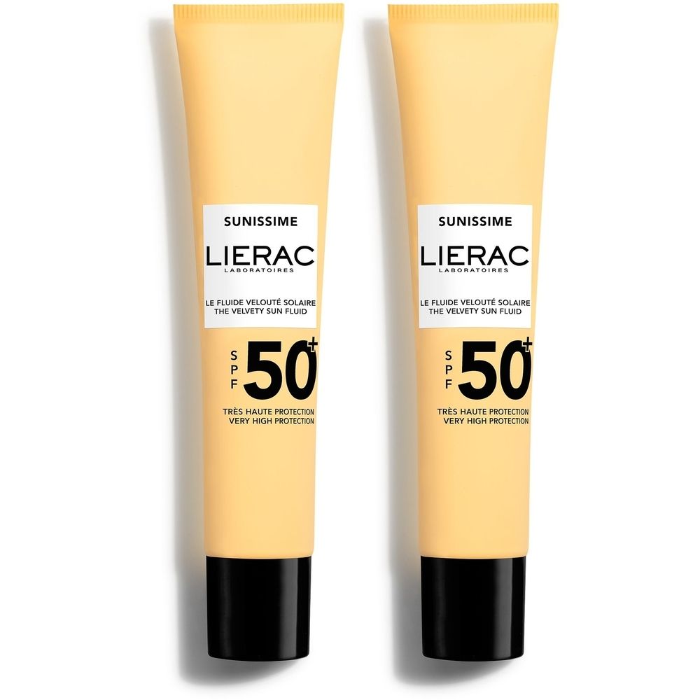Deux tubes de Lierac Sunissime Le Fluide Velouté Solaire SPF 50+. Tubes beiges, bouchons noirs. Texte: SPF 50, Sunissime, Lierac.