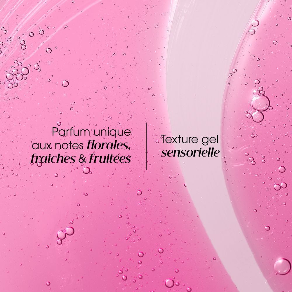 Liquide rose avec bulles. Texte: Parfum unique aux notes florales, fraîches & fruitées. Texture gel.