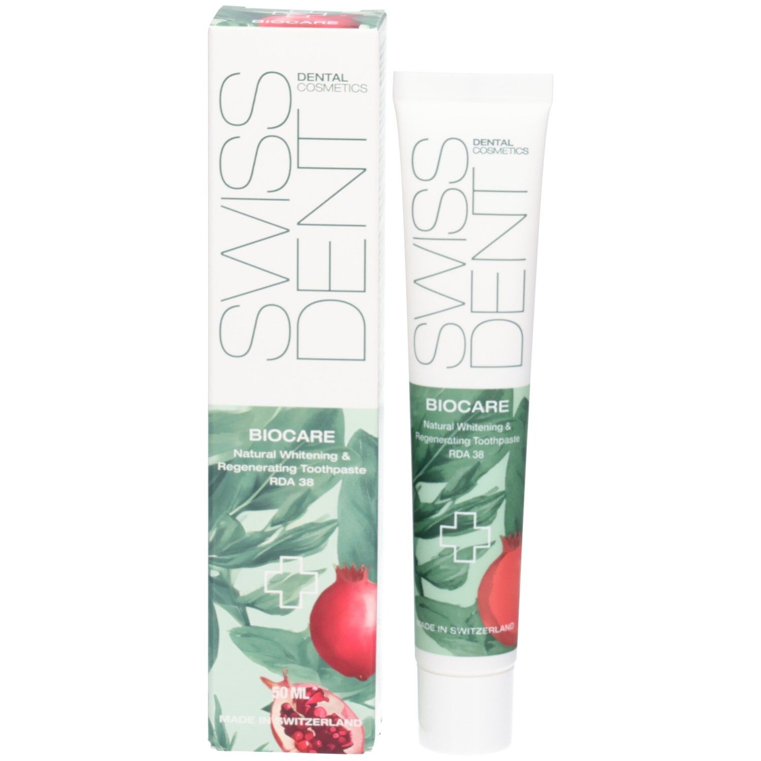 Zahncreme-Tube und Schachtel. SWISSDENT und BIOCARE Schriftzug. Granatapfel-Illustration. Grün-weißes Design.