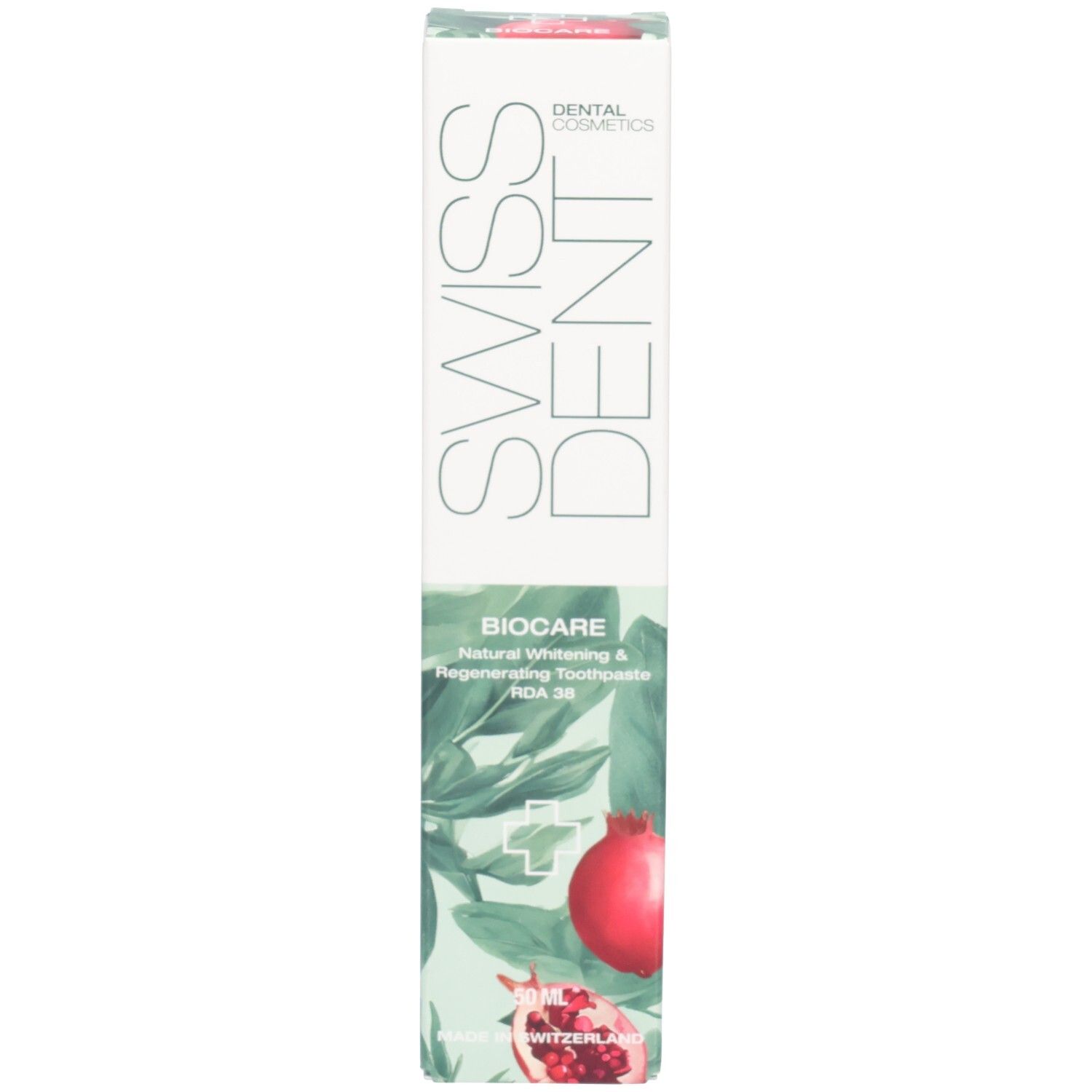 Zahncreme-Schachtel mit SWISSDENT und BIOCARE Schriftzug. Granatapfel-Illustration. Grün-weißes Design.