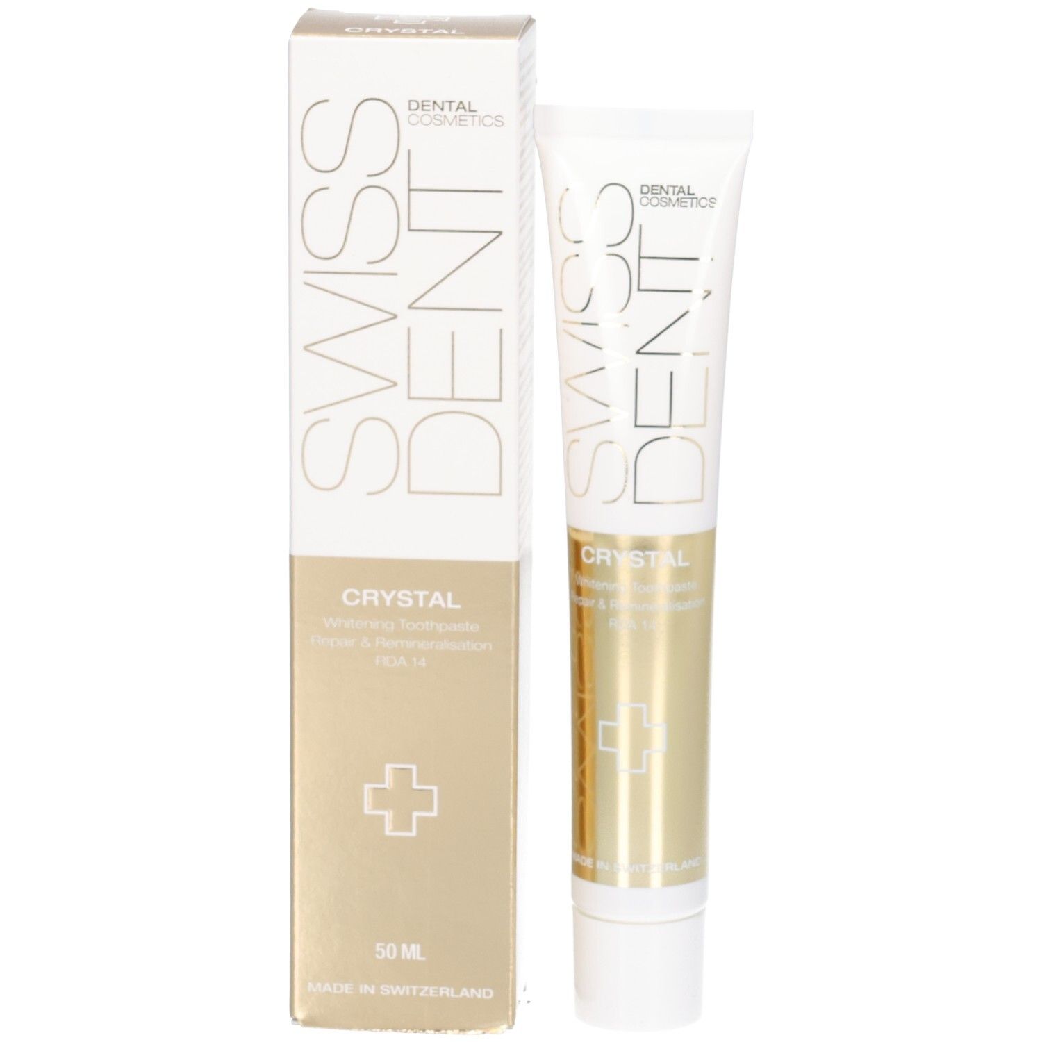 Zahncreme-Tube und Schachtel. Aufschrift SWISSDENT CRYSTAL. Goldfarbene Bereiche. Weißes Kreuz. 50 ml. Vertikale Ausrichtung.