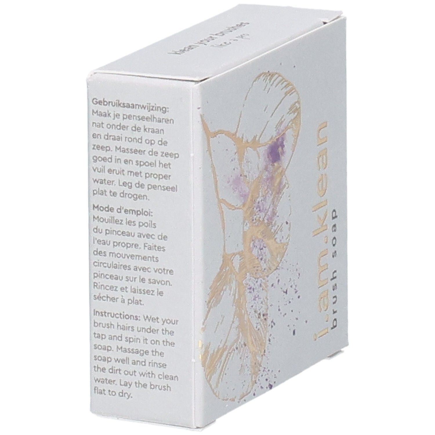 Schräg stehende Kartonverpackung mit floralem Design. Aufschrift i.am.klean Brush Soap. Anweisungen in mehreren Sprachen.