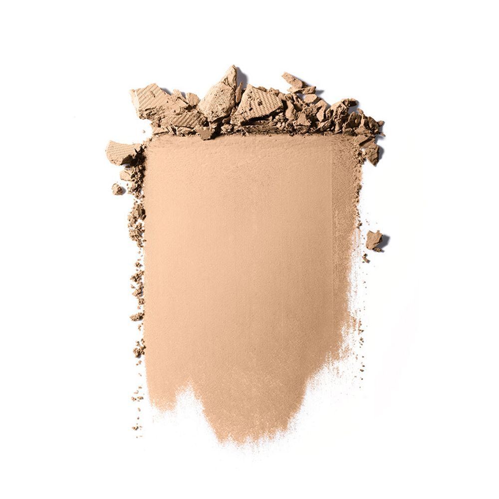 Un morceau de poudre compacte cassée avec une texture visible.