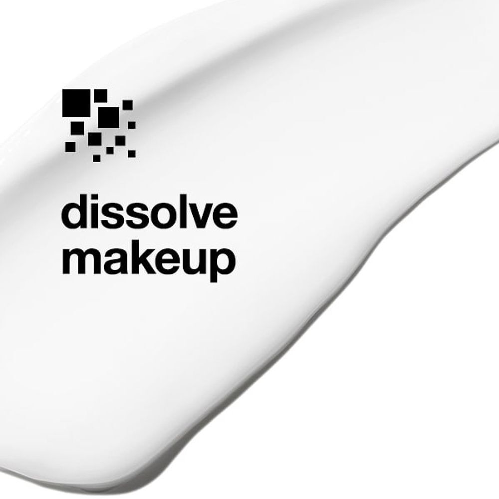 Weiße Creme mit Text "dissolve makeup" und einem Symbol aus schwarzen Quadraten.