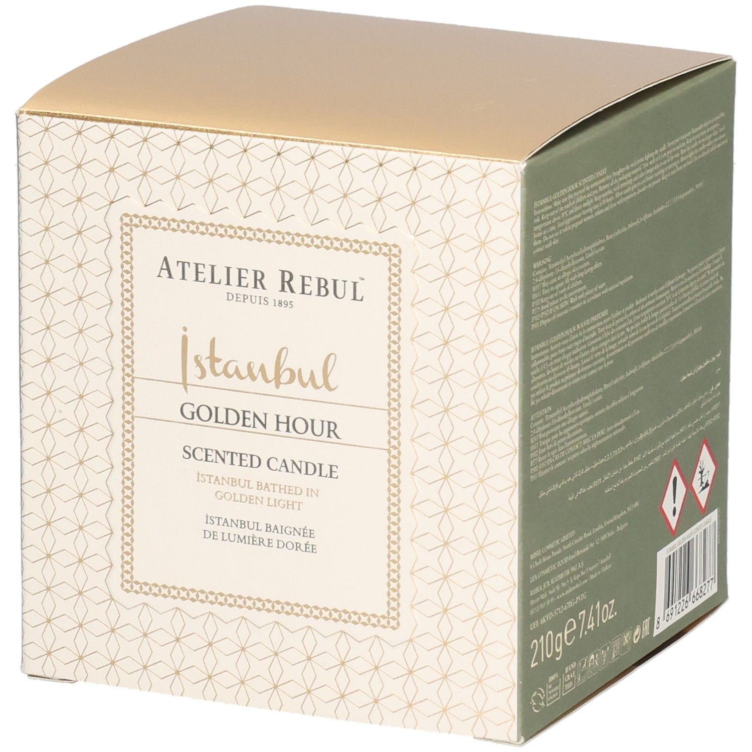 Boîte carrée. Inscription: Atelier Rebul, Istanbul Golden Hour Scented Candle. Couvercle doré, côtés crème avec motif.