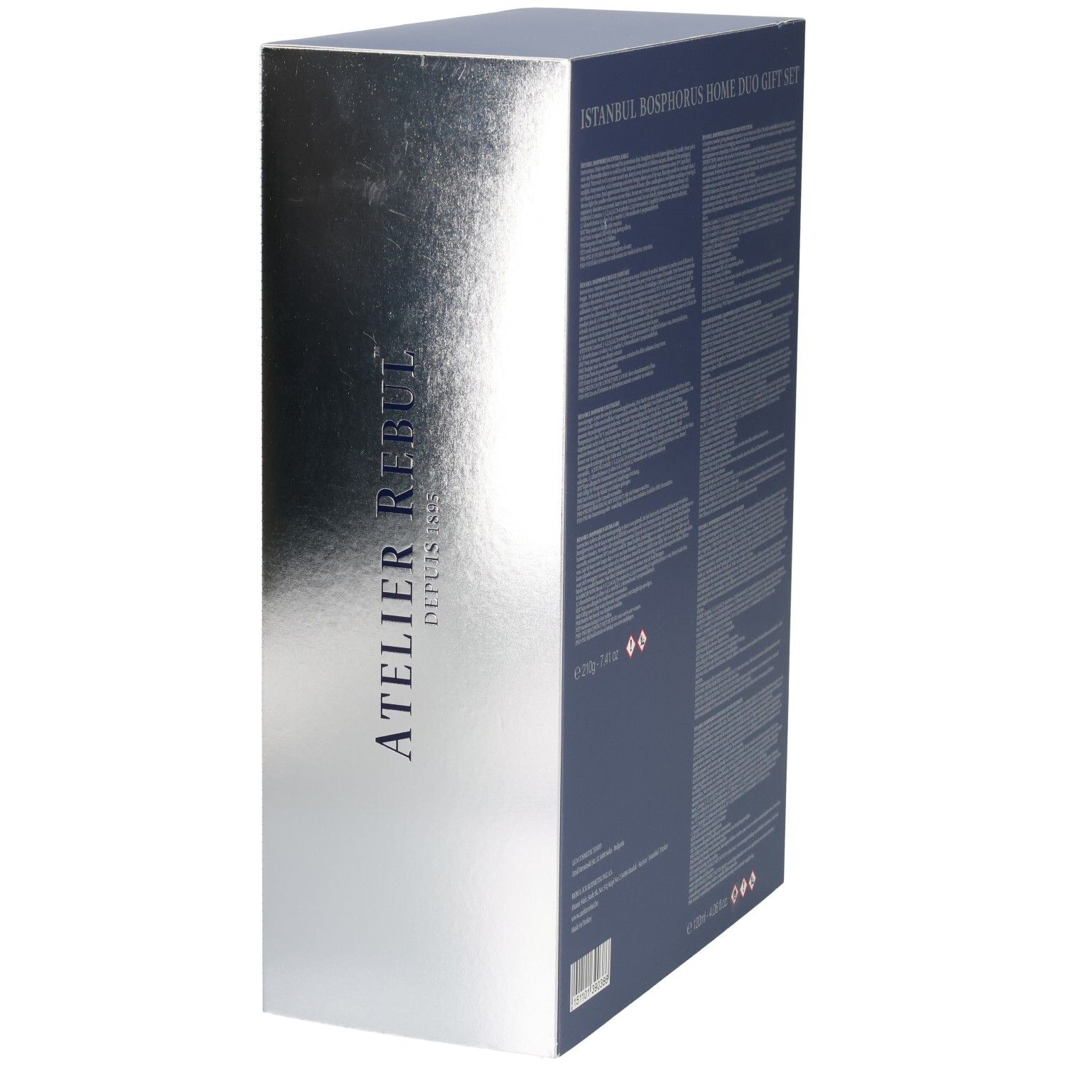 Seitenansicht einer Geschenkbox mit silberner Metallic-Oberfläche und vertikalem Atelier Rebul Schriftzug.