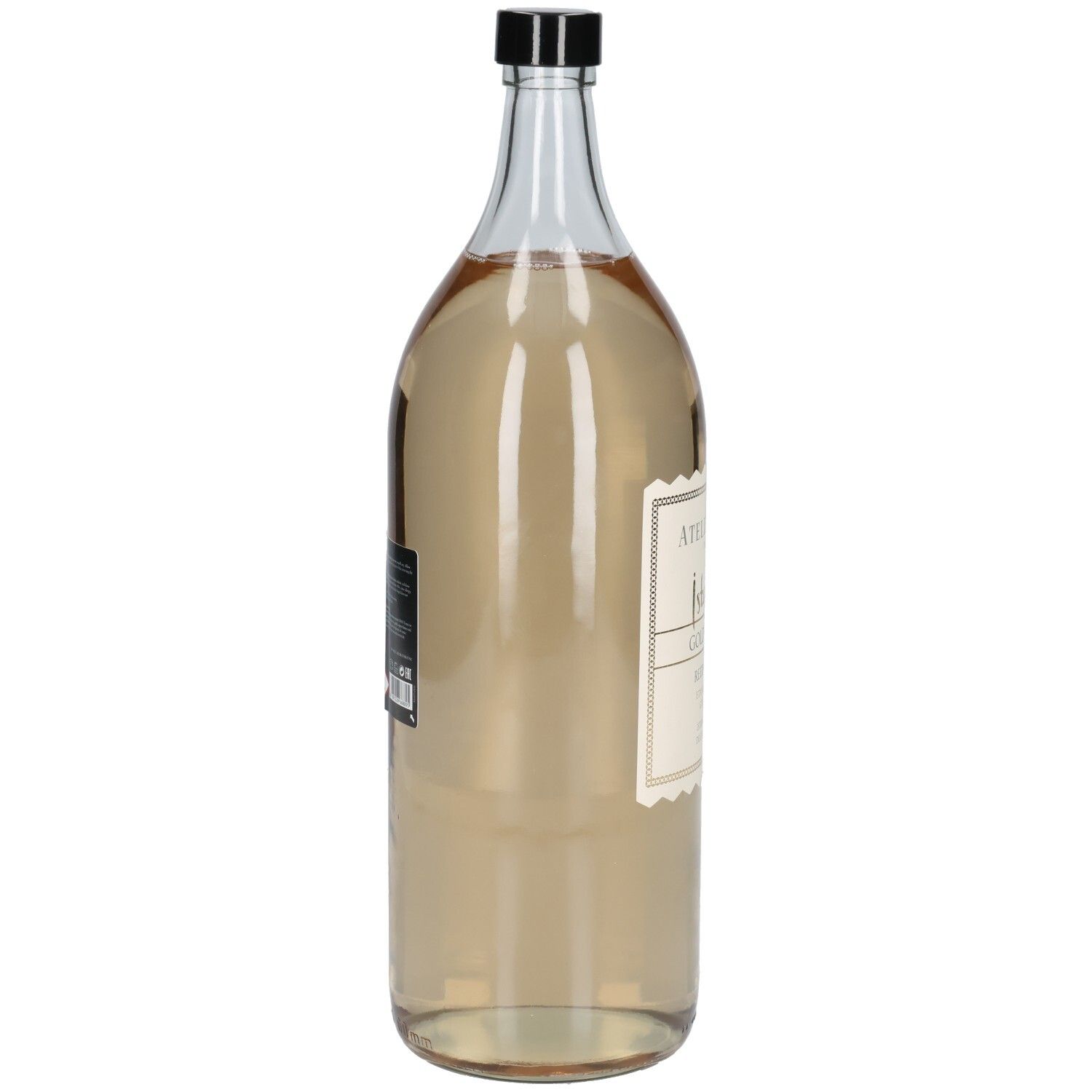 Transparente Glasflasche mit schwarzem Deckel. Etikett mit Produktinformationen. Flüssigkeit in der Flasche ist goldfarben.