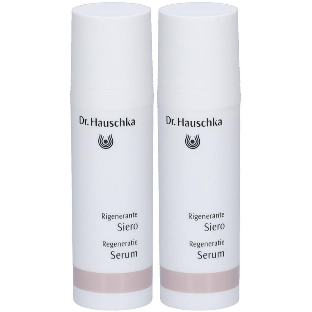 Zwei Dr. Hauschka Regenerierende Serum Flaschen, weiß mit rosa Band.