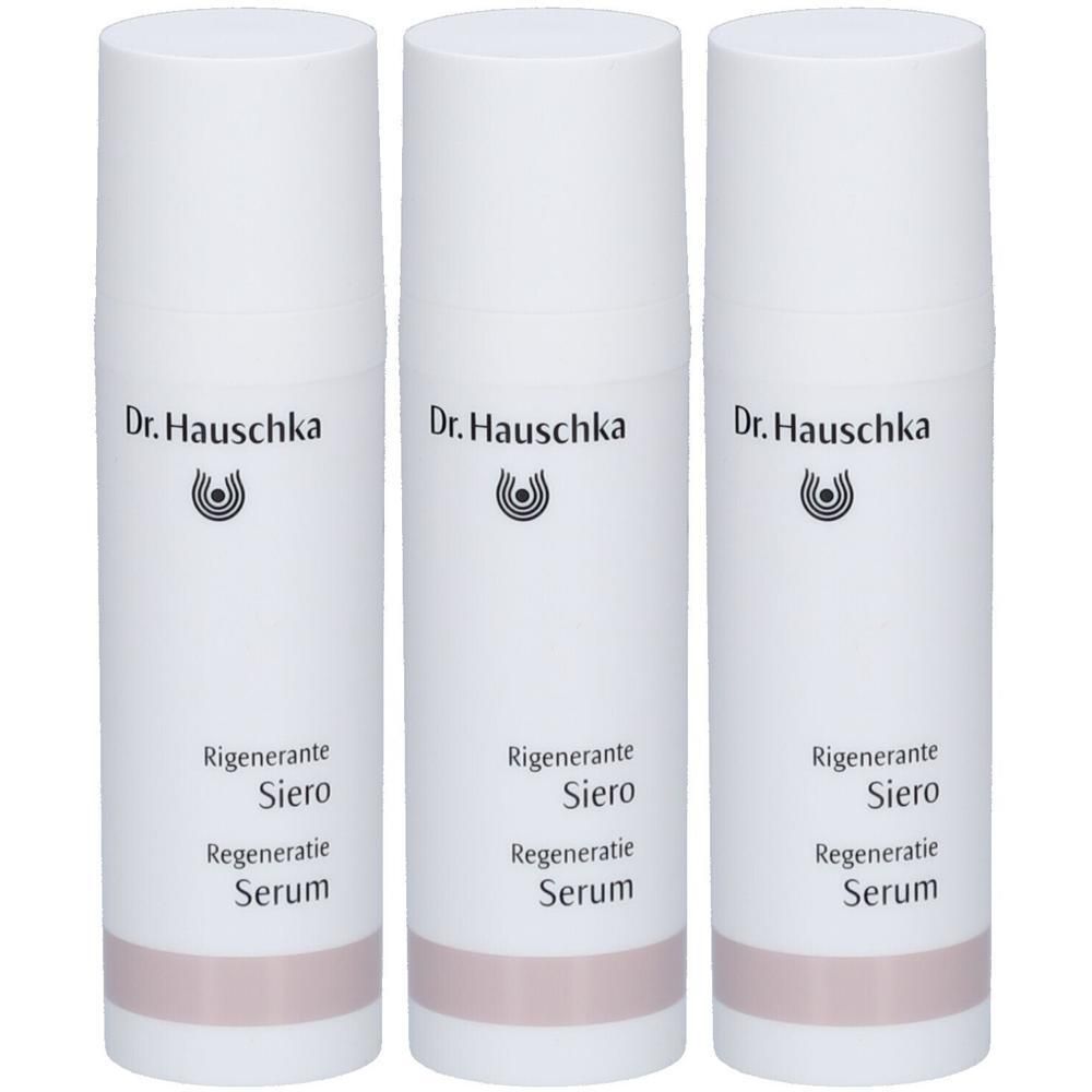 Trois flacons blancs Dr. Hauschka Sérum régénérant avec pompe et bande rose.