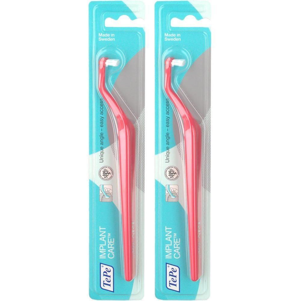 Zwei TePe Implant Care Einbüschelbürsten in Pink, verpackt in einer Blisterpackung mit blauer Rückseite.
