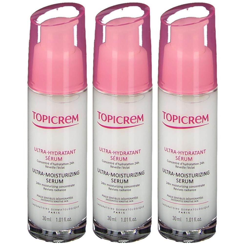 Drei Flaschen Topicrem Ultra-Feuchtigkeitsspendendes Serum mit rosa Pumpaufsätzen.