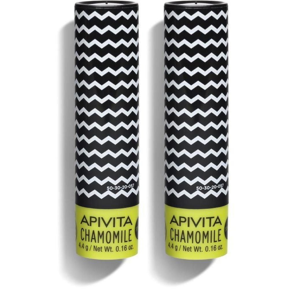 Deux emballages de baume à lèvres avec motif en zigzag et base jaune. Contient de la camomille et SPF15.