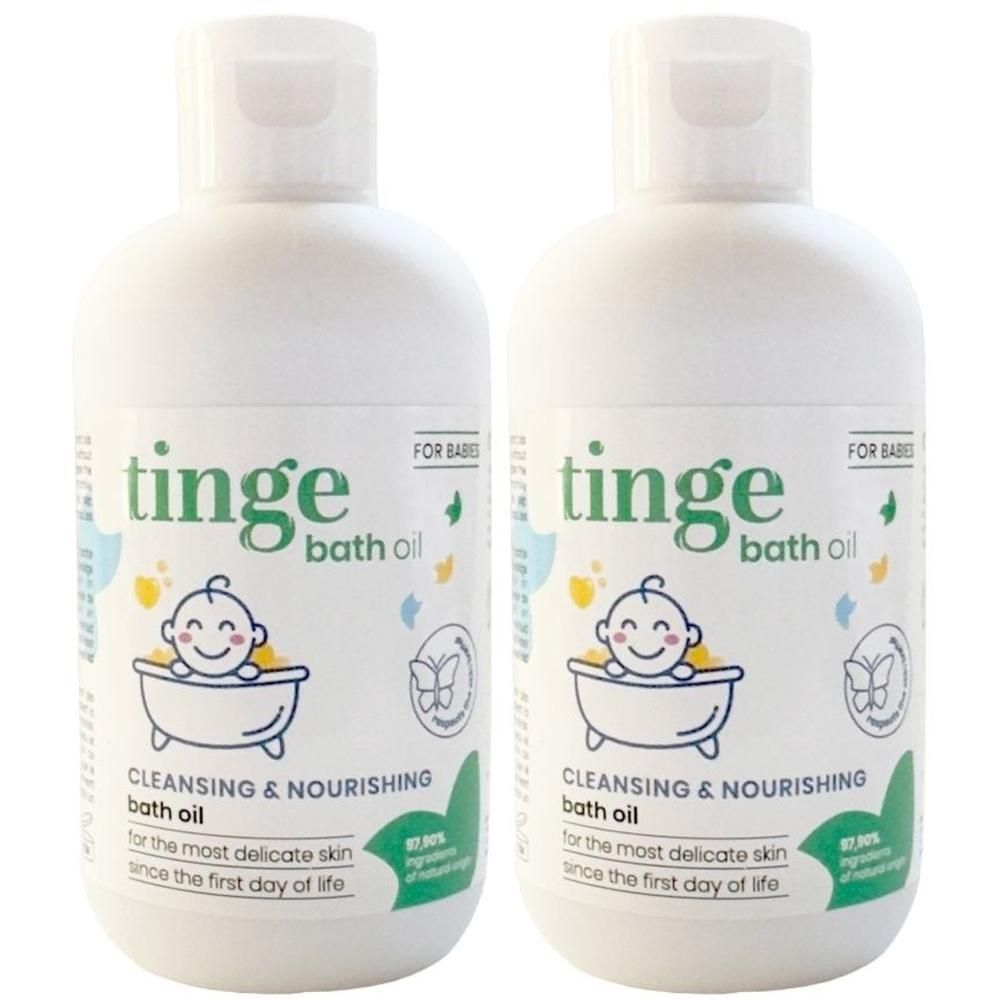 Deux flacons blancs d'huile de bain Tinge pour bébés avec des éclaboussures colorées sur l'étiquette.