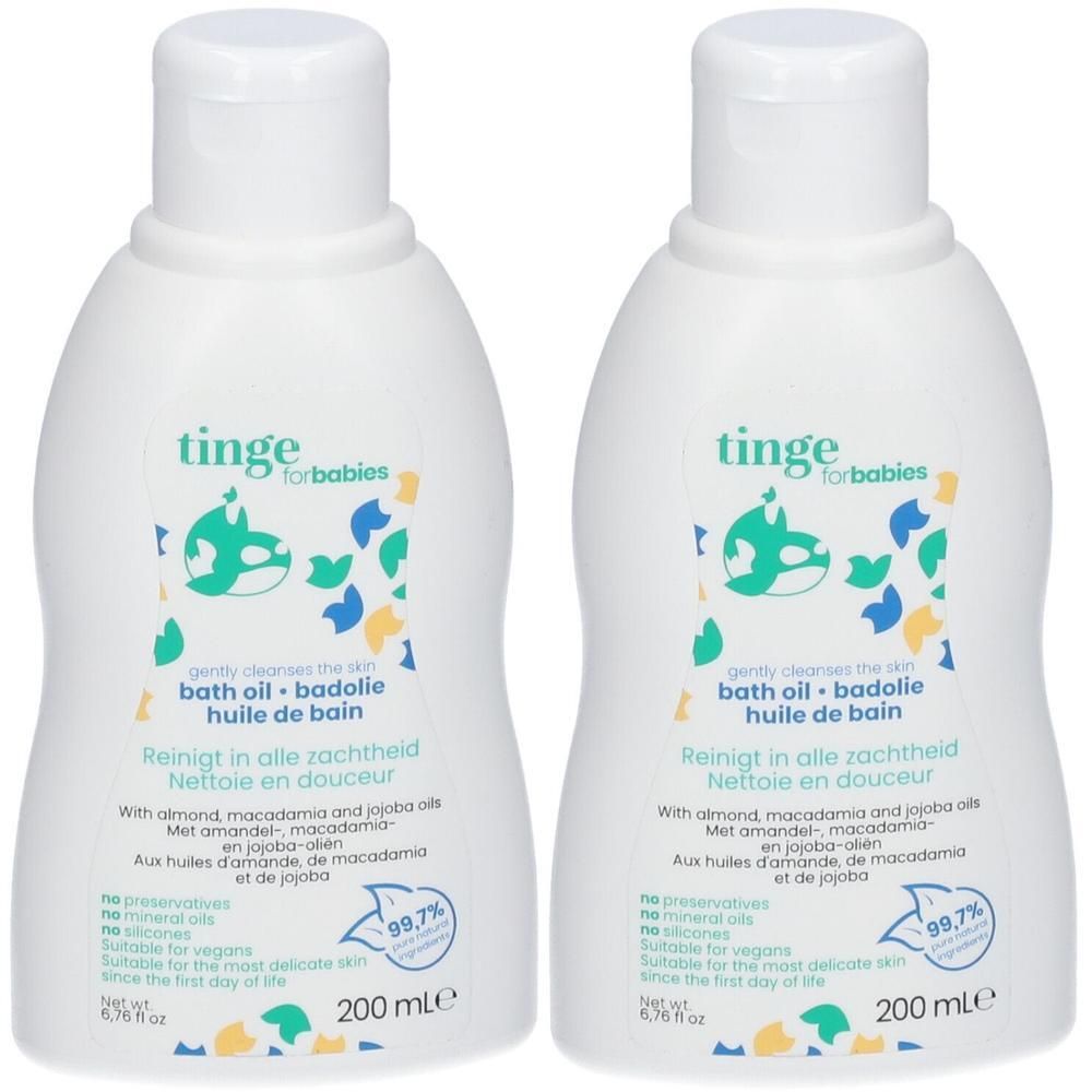 Deux flacons blancs d'huile de bain Tinge pour bébés avec des éclaboussures colorées sur l'étiquette.