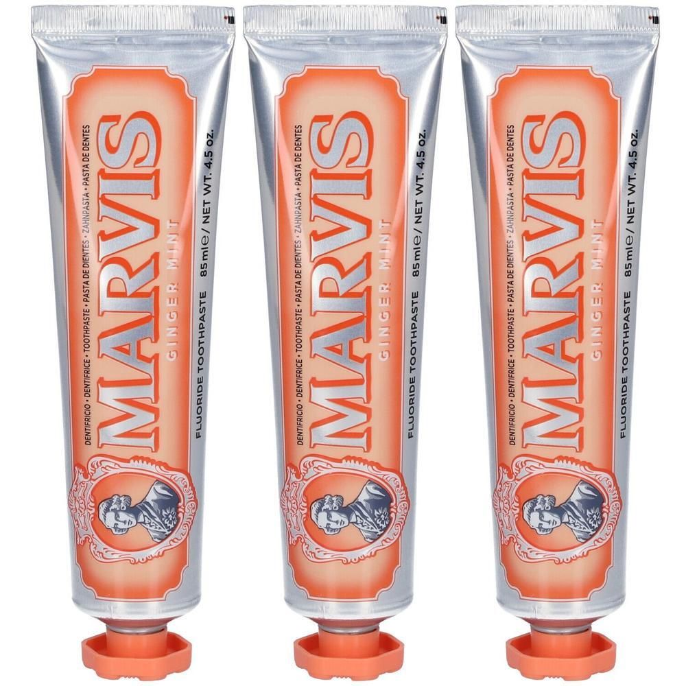 Trois tubes de dentifrice au fluor Marvis Gingembre Menthe, avec étiquette orange et bouchon argenté.