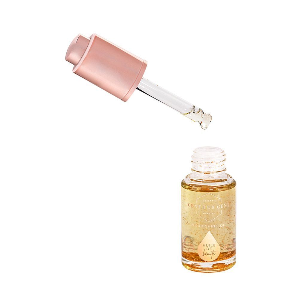 Un flacon d'huile de beauté avec une pipette tenant une goutte de liquide.
