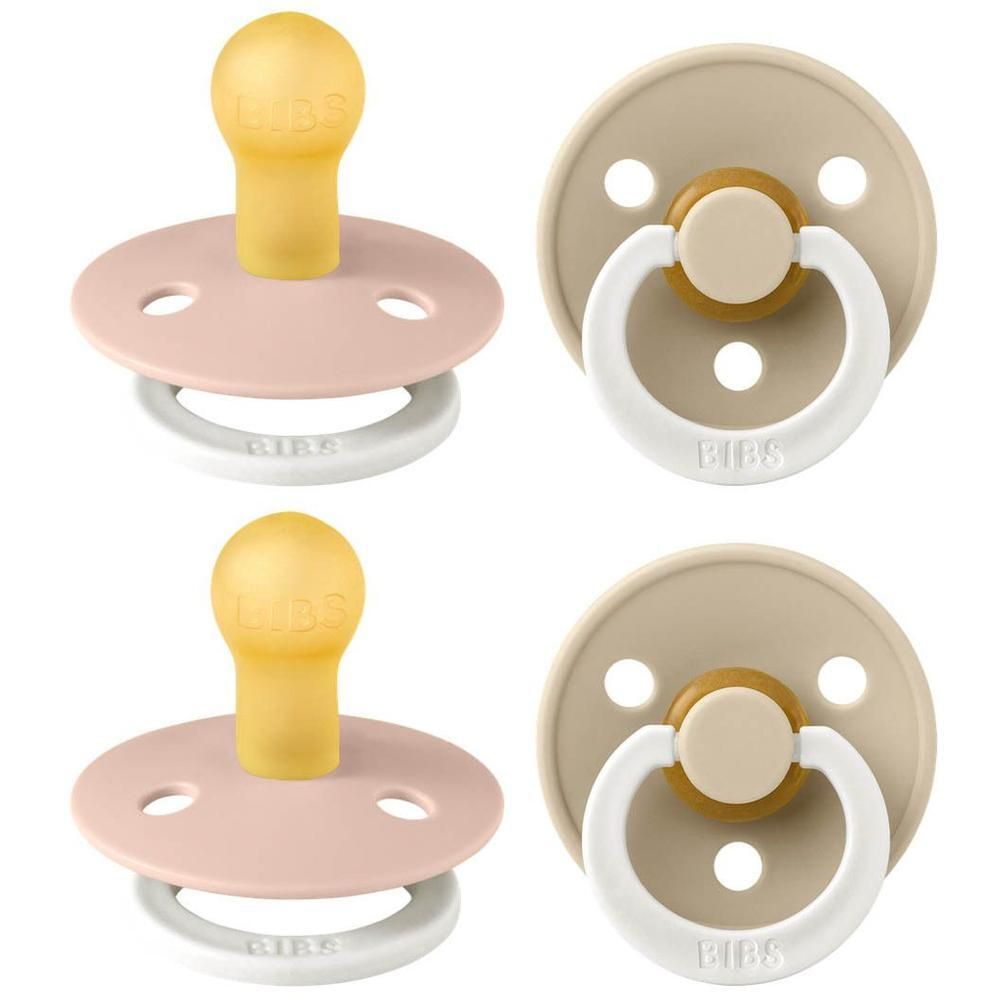 Deux paquets de sucettes BIBS Colour, taille 1, rose et beige. Brille dans le noir.