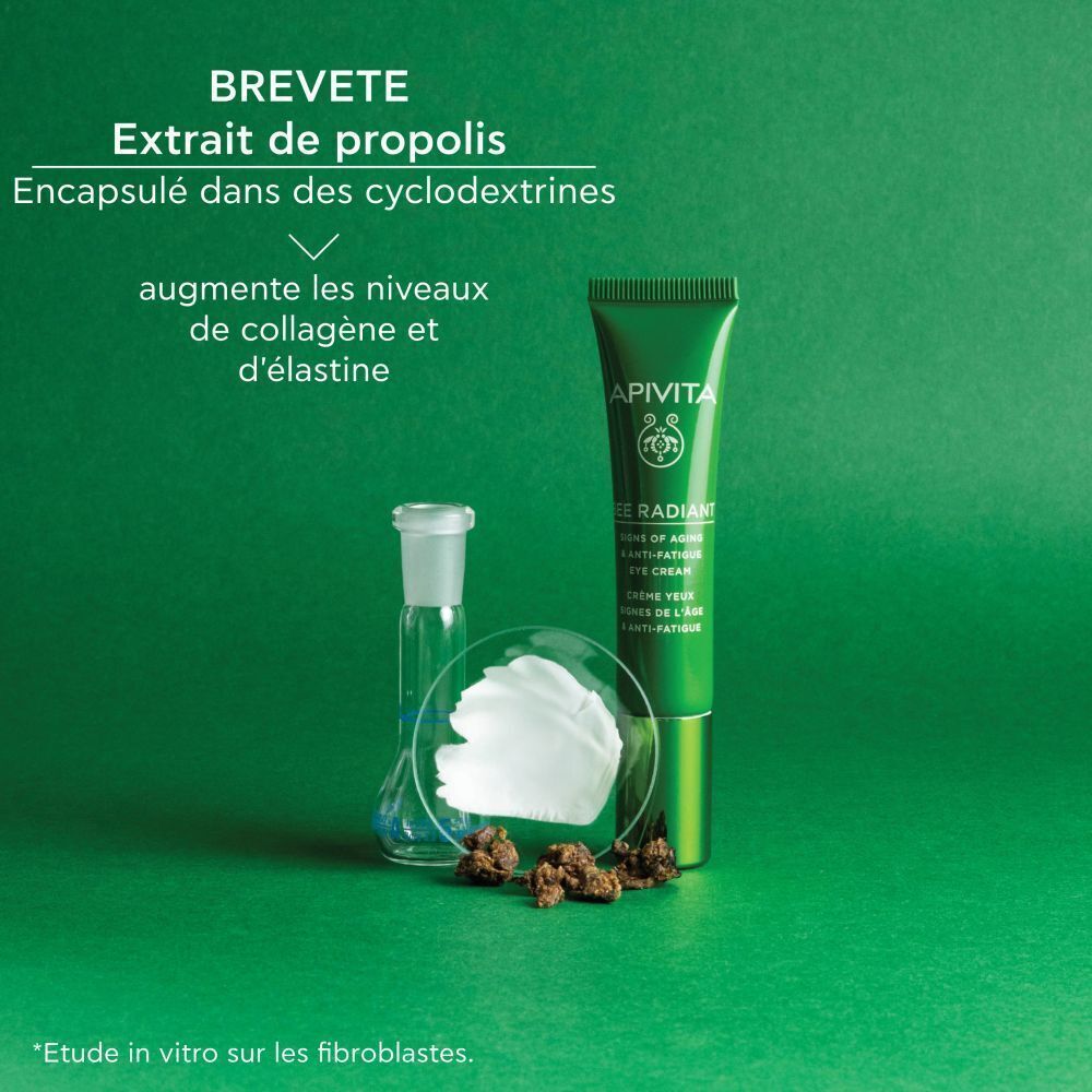 Tube vert de crème pour les yeux à côté d'équipements de laboratoire et de morceaux de propolis. Texte en français.
