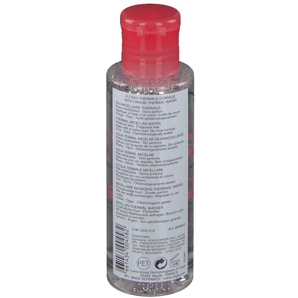 Rückseite der Flasche mit rotem Deckel. Produktinformationen in mehreren Sprachen. PET-Recycling-Symbol.