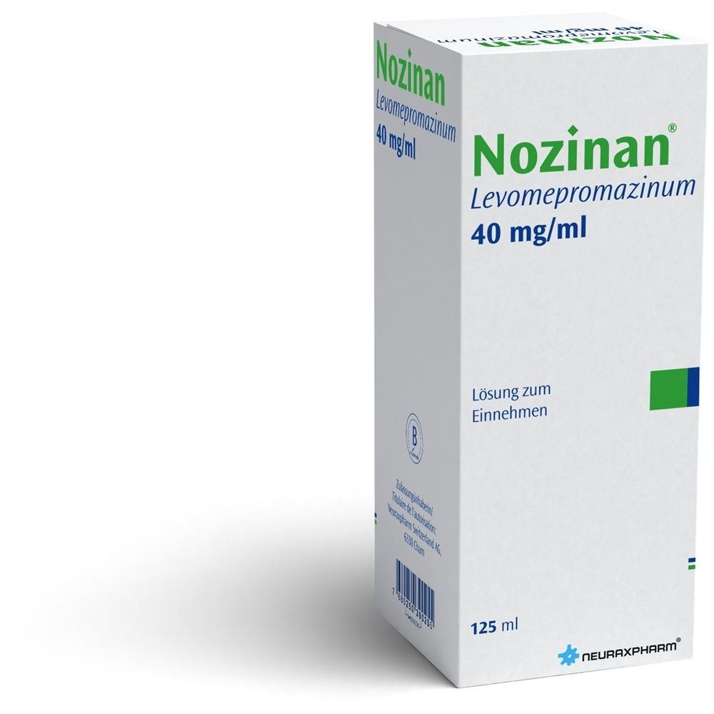 Emballage en carton avec texte vert et bleu. Le nom NOZINAN est visible. L'emballage est sur fond blanc.