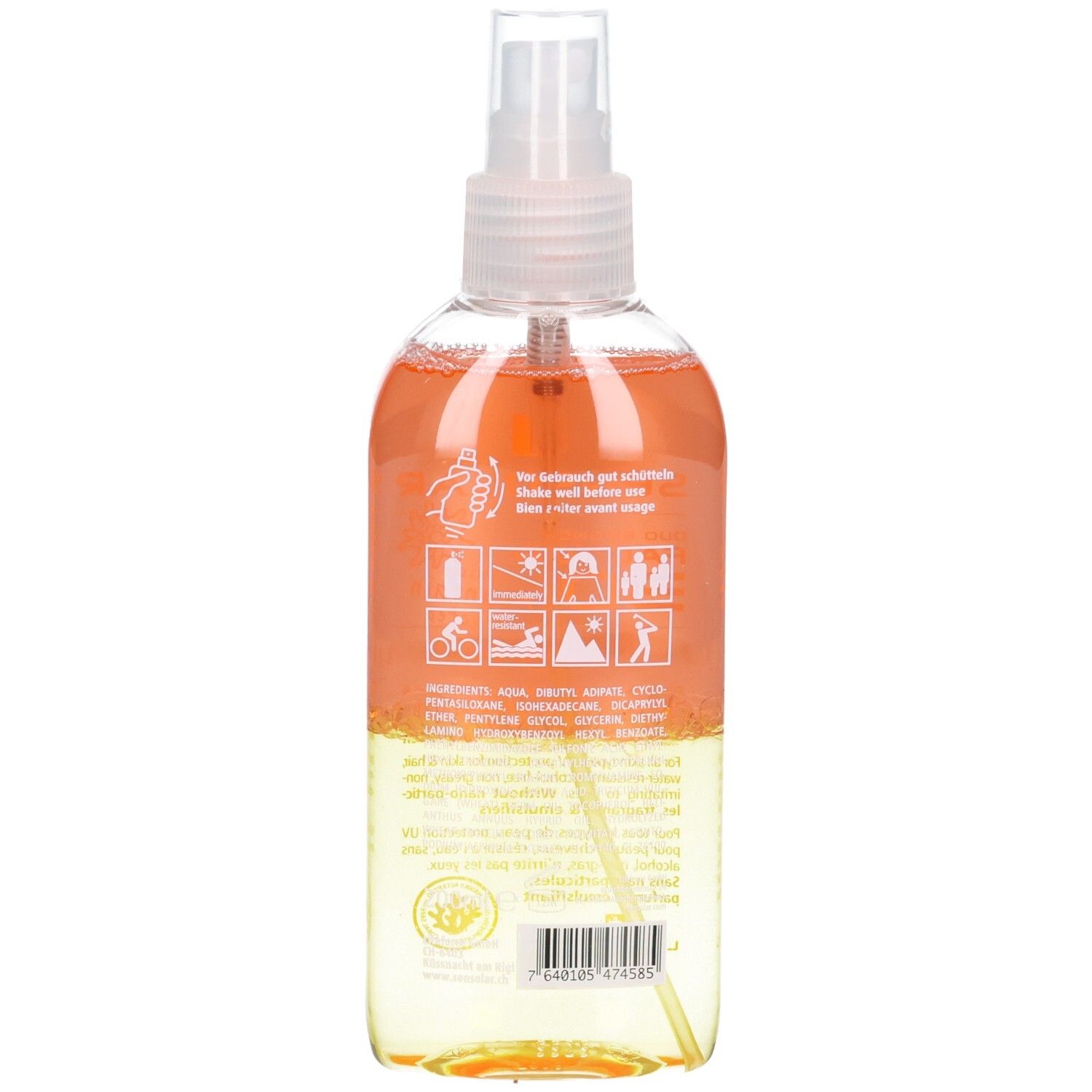 Rückseite der Sonnenspray-Flasche. Transparent, mit orangefarbener und gelber Flüssigkeit. Text und Piktogramme.