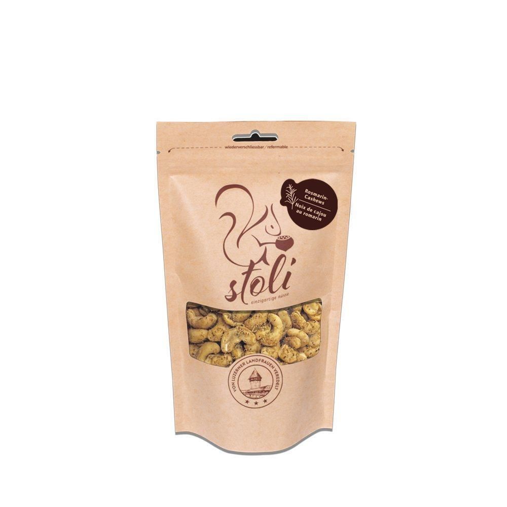 STOLI Cashewnüsse mit Rosmarin in brauner Papiertüte mit Sichtfenster.