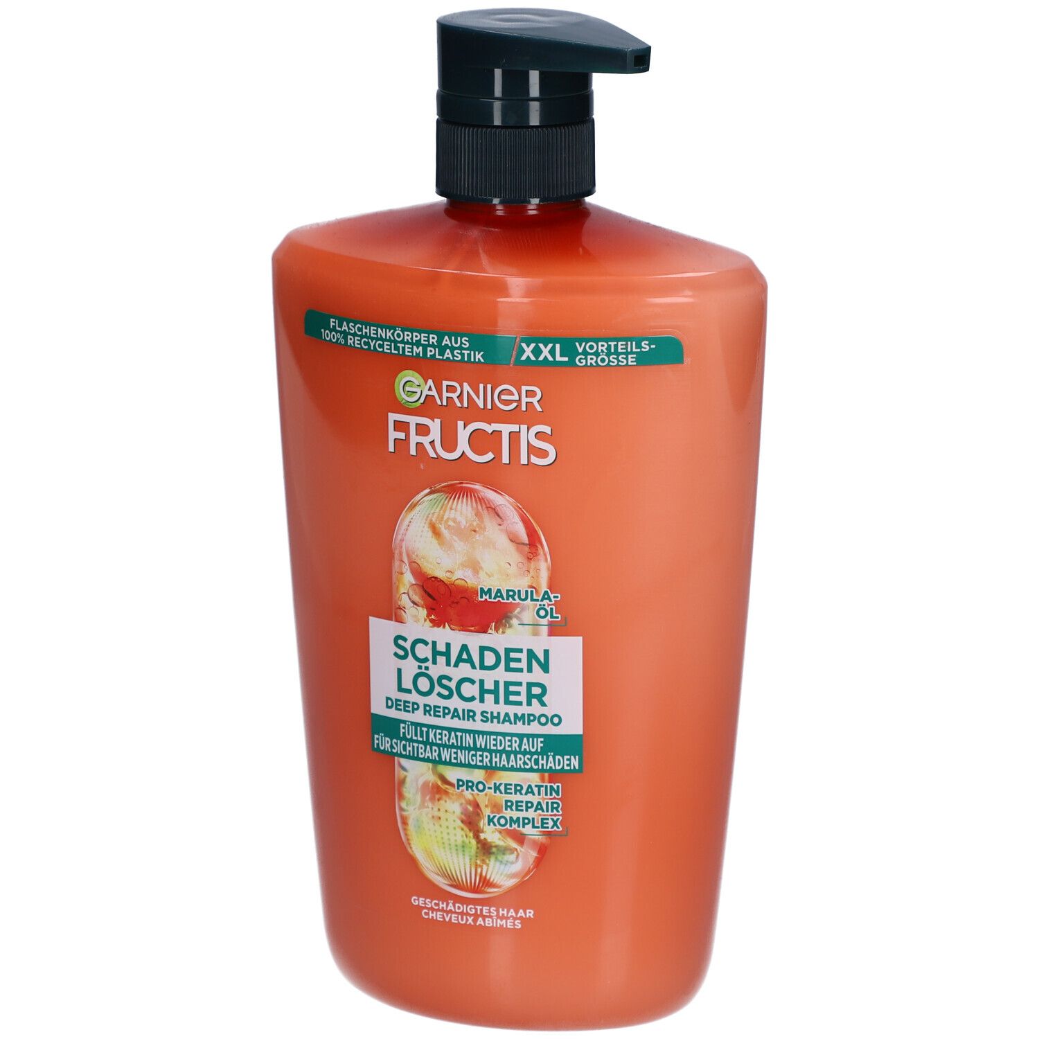 Flacon de shampooing orange avec pompe noire. Inscriptions: Garnier Fructis, Schadenlöscher, huile de marula.