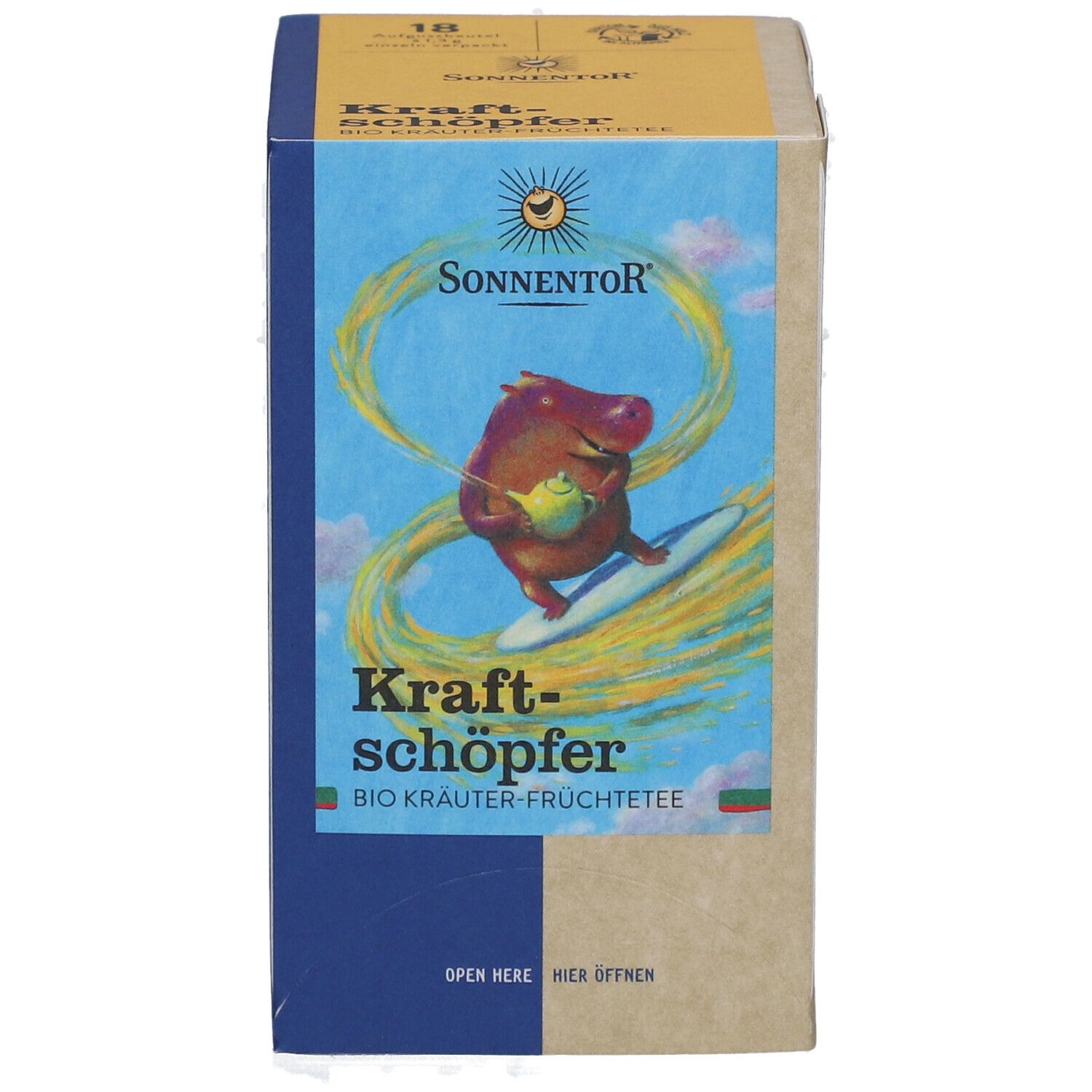 Karton mit Produktabbildung. Aufdruck: SONNENTOR, Kraftschöpfer, Bio-Kräuter-Früchtetee. Abbildung eines Nilpferds auf Surfbrett.
