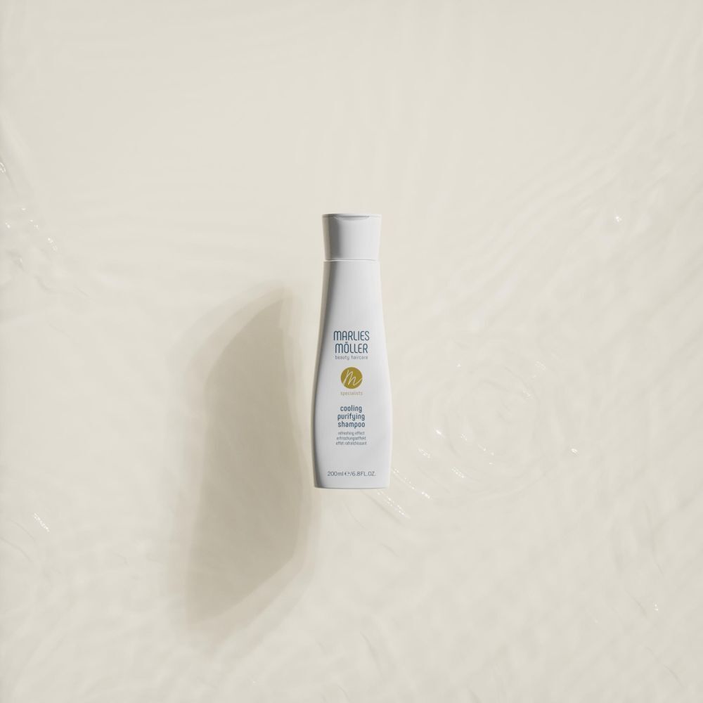 Flacon blanc avec bouchon blanc. Inscription: Marlies Möller, cooling purifying shampoo. Sur fond clair.