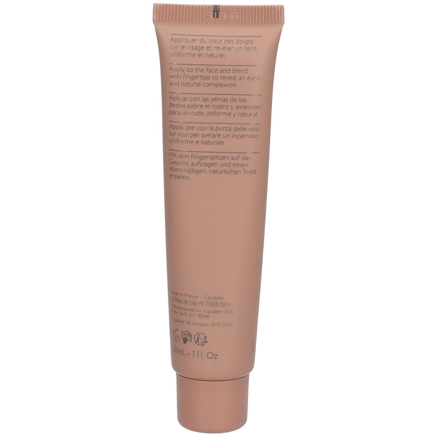 Dos du tube de crème rose. Texte multilingue: instructions d'utilisation, ingrédients.