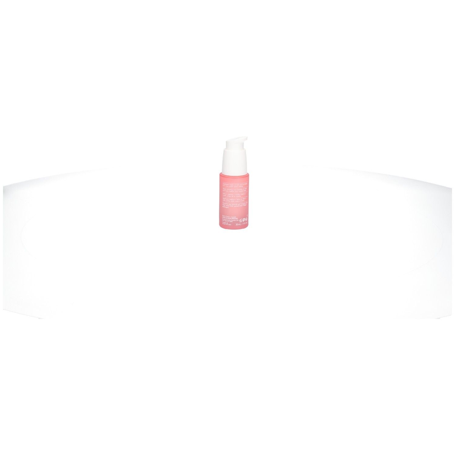 Flacon rose avec pompe blanche. Produit isolé sur fond blanc.