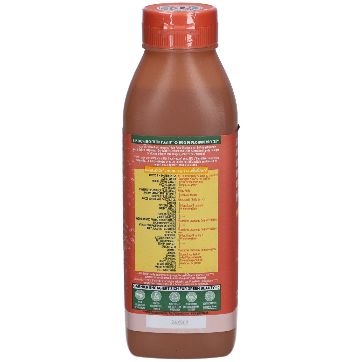 Rückseite der Shampoo-Flasche. Etikett mit Inhaltsstoffen und Herstellerinformationen. Orangefarbener Deckel. Recycling-Hinweis.