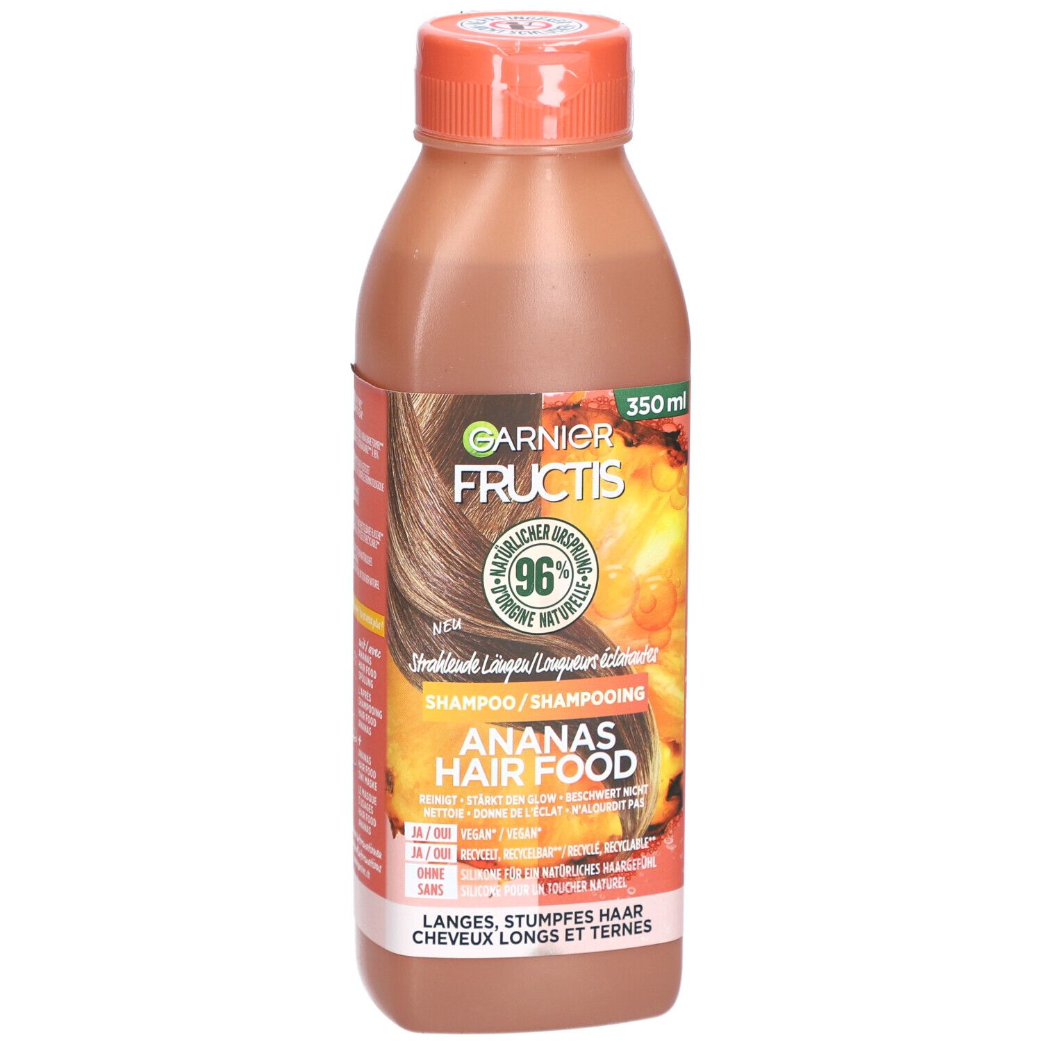 Garnier Fructis Hair Food Ananas-Glanzshampoo Flasche. Orangefarbener Deckel, braune Flüssigkeit. Etikett mit Produktinformationen.