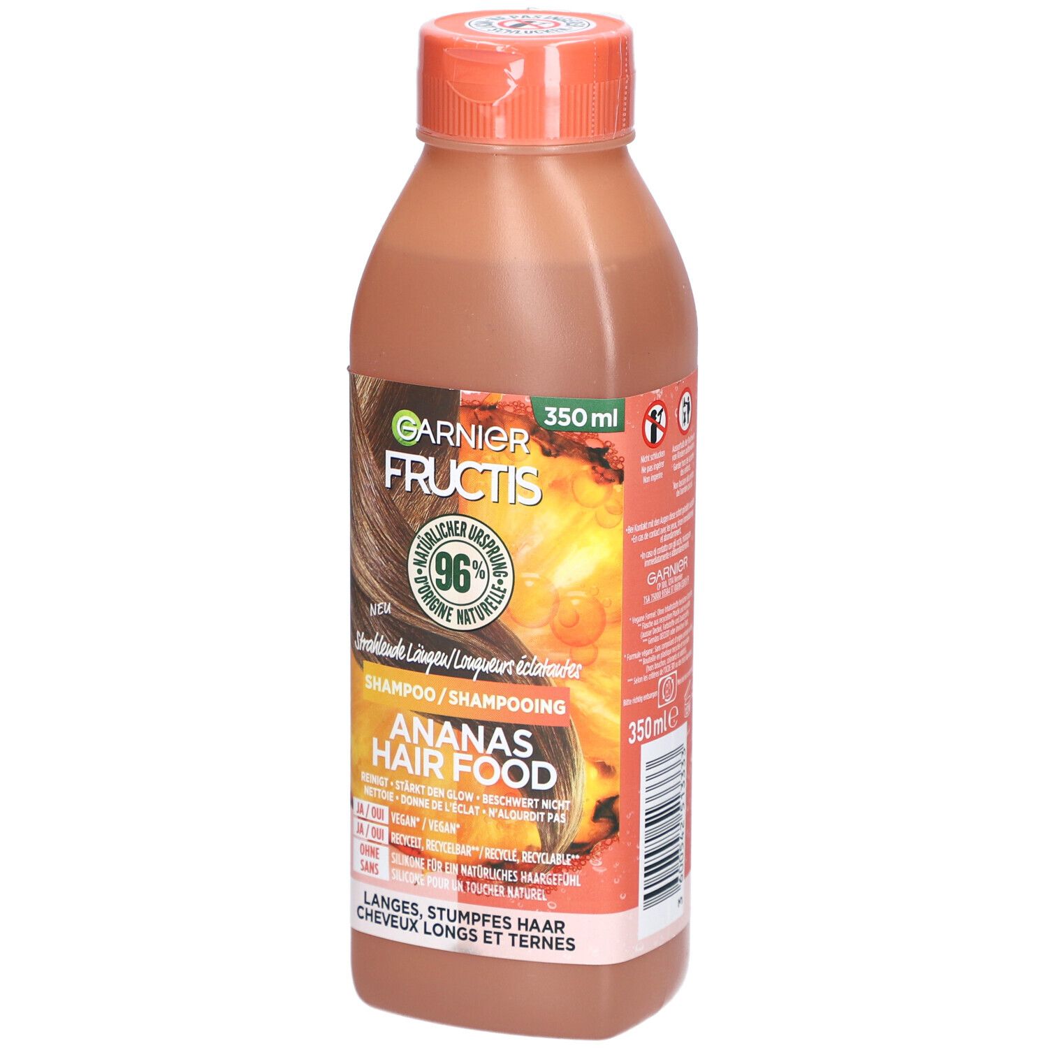 Garnier Fructis Hair Food Ananas-Glanzshampoo Flasche. Orangefarbener Deckel, braune Flüssigkeit. Etikett mit Produktinformationen.