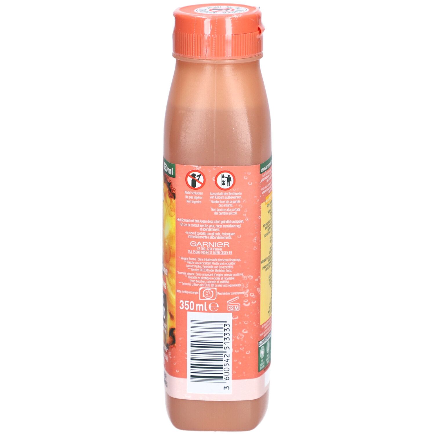 Rückseite der Shampoo-Flasche. Etikett mit Produktinformationen, Barcode und Herstellerangaben. Orangefarbener Deckel.