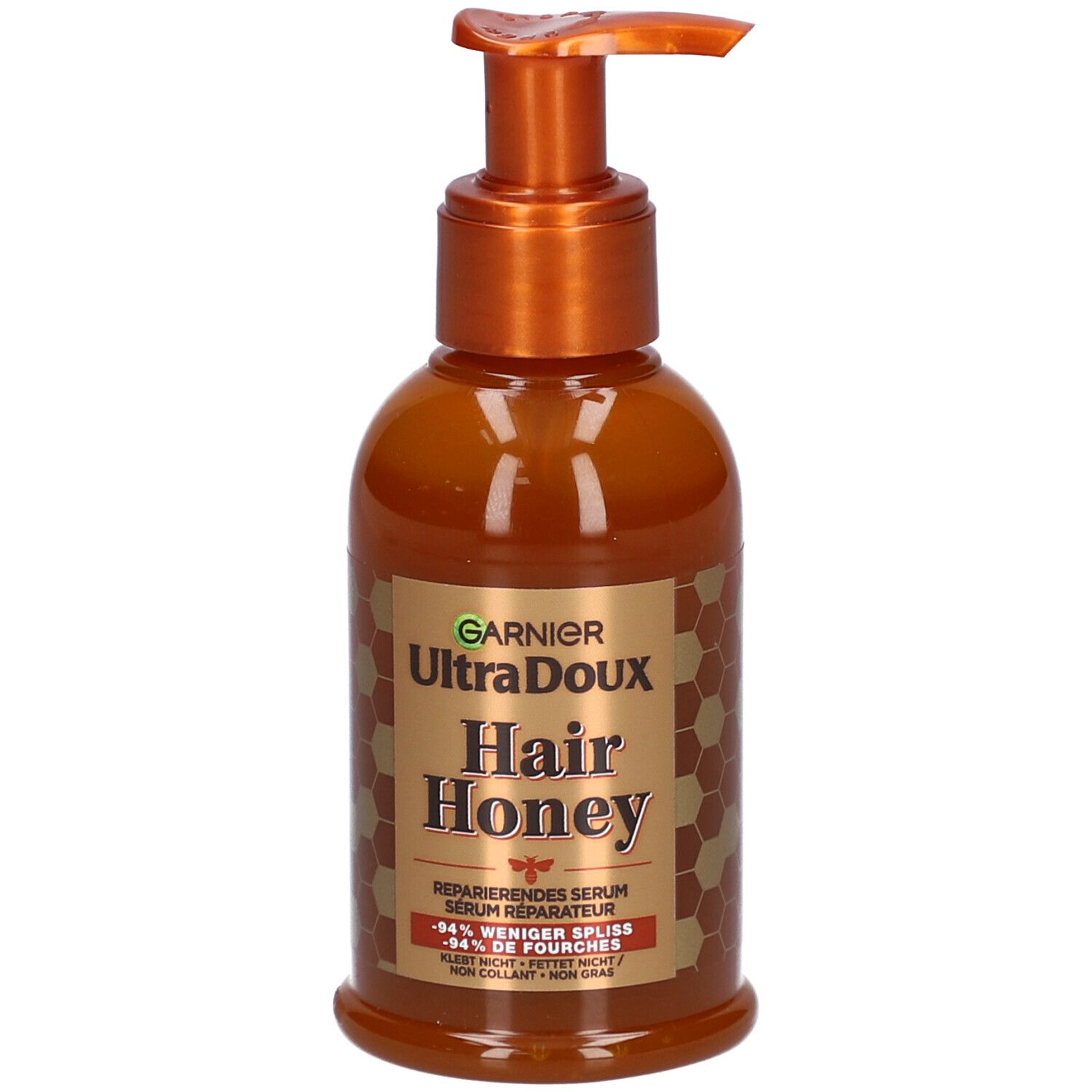 Braune Flasche mit Pumpe. Aufschrift: Garnier Ultra Doux Hair Honey. Reparierendes Serum. Honig-Design.