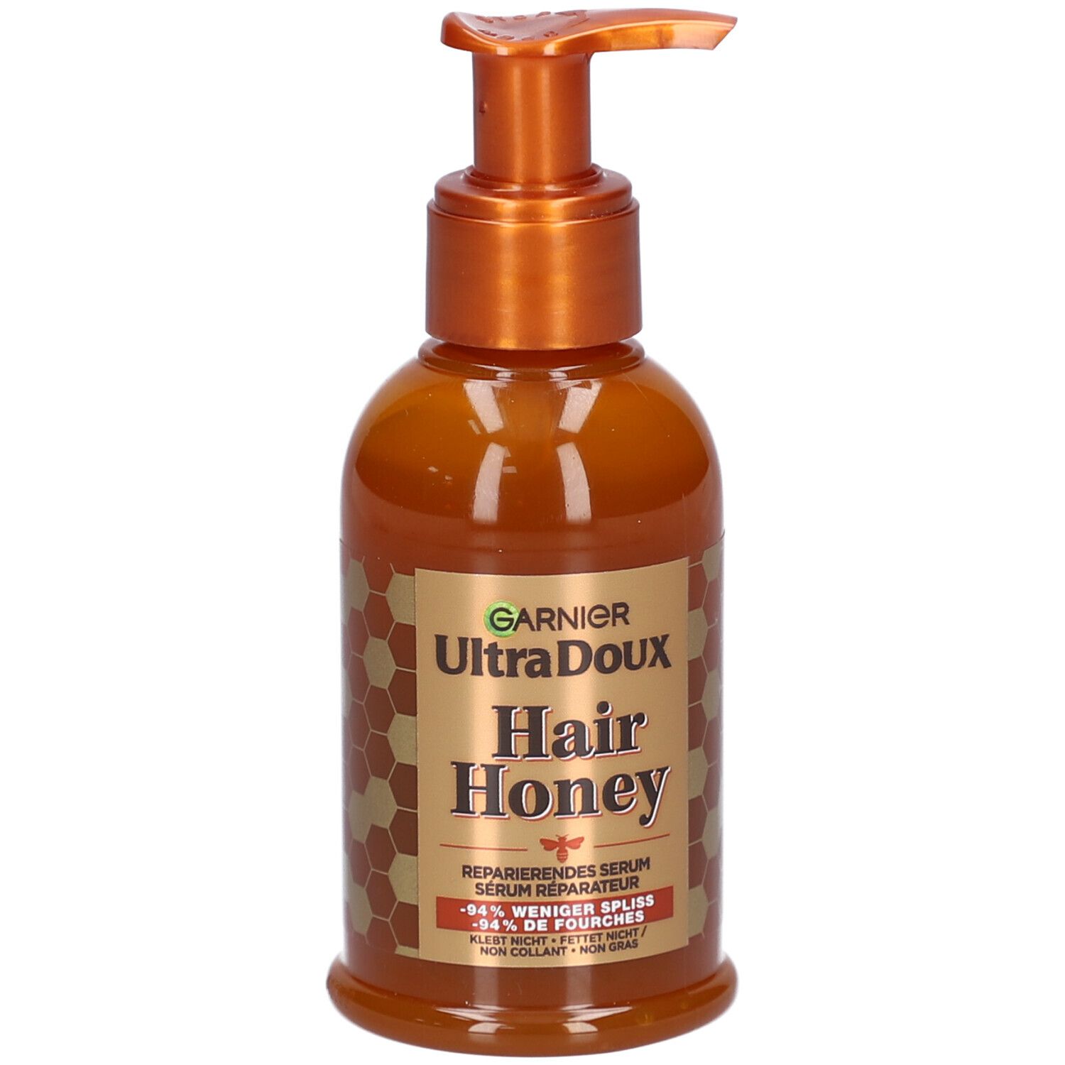 Braune Flasche mit Pumpe. Aufschrift: Garnier Ultra Doux Hair Honey. Reparierendes Serum. Honig-Design.