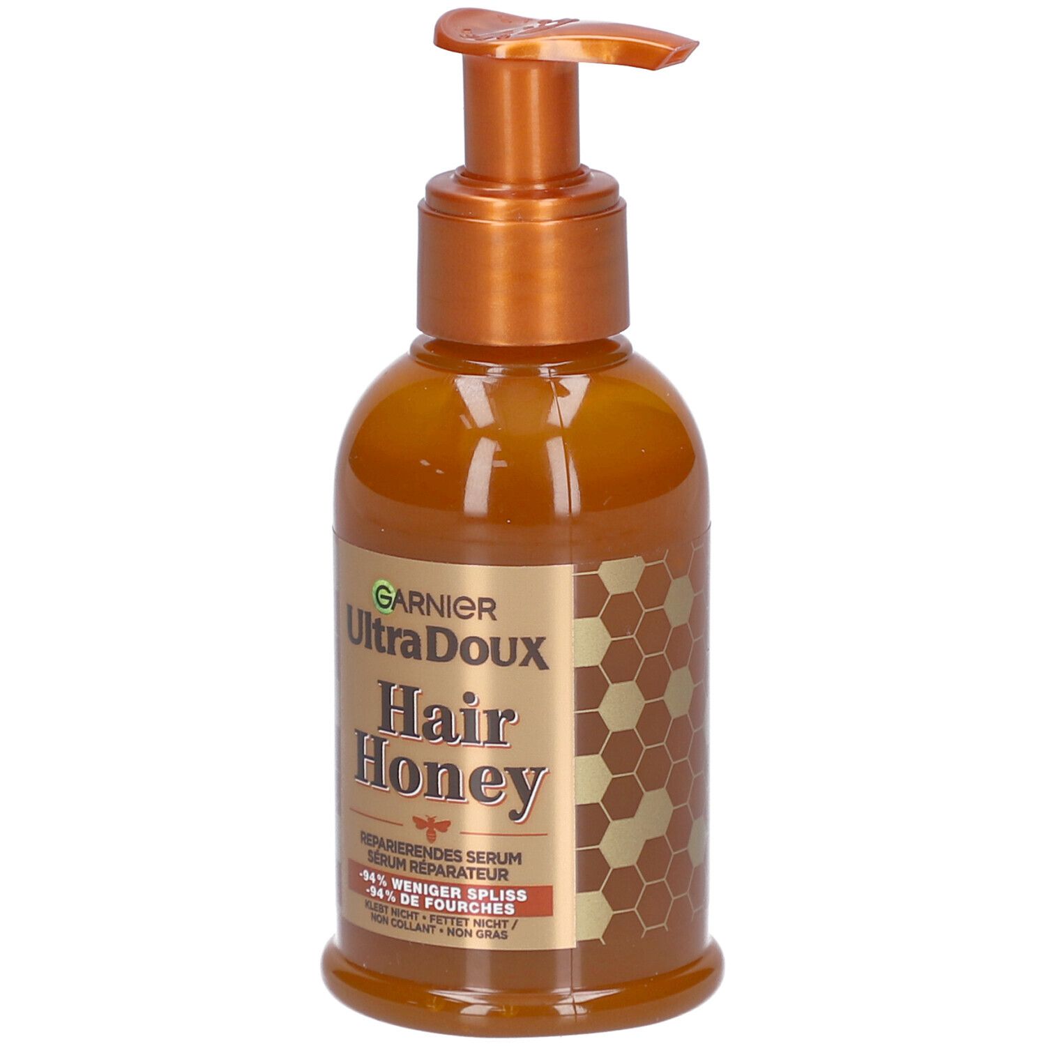 Braune Flasche mit Pumpe. Aufschrift: Garnier Ultra Doux Hair Honey. Reparierendes Serum. Honig-Design.